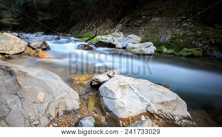 Water From Small Mountain River Blurred As It Moves Downstream