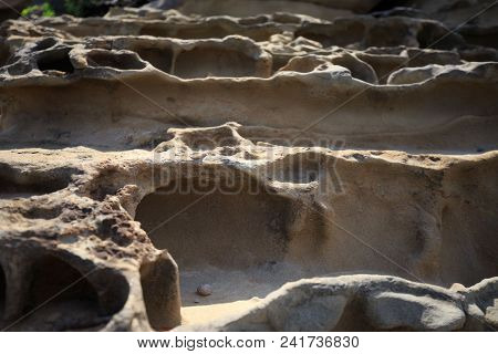 Wave And Wind Battered Cliffs Erode Into Terraced Steps