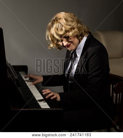 Beautiful Woman In A Business Suit Playing The Piano