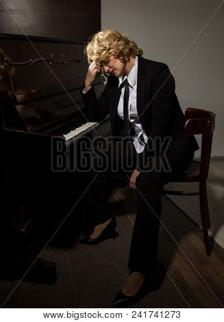 Beautiful Woman In A Business Suit Playing The Piano