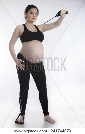 Pregnant Woman Doing Gymnastic Exercises On White Background