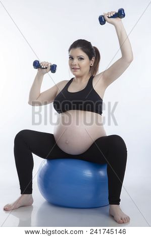 Pregnant Woman Is Doing Exercises With Gymnastic Ball On White Background