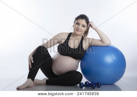 Pregnant Woman Is Doing Exercises With Gymnastic Ball On White Background