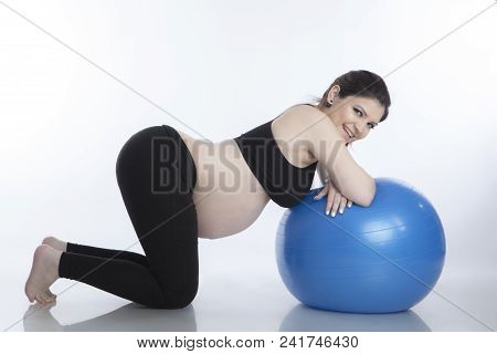 Pregnant Woman Is Doing Exercises With Gymnastic Ball On White Background