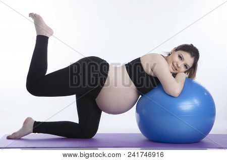 Pregnant Woman Is Doing Exercises With Gymnastic Ball On White Background