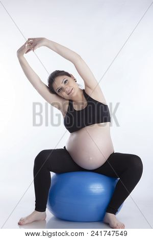 Pregnant Woman Is Doing Exercises With Gymnastic Ball On White Background
