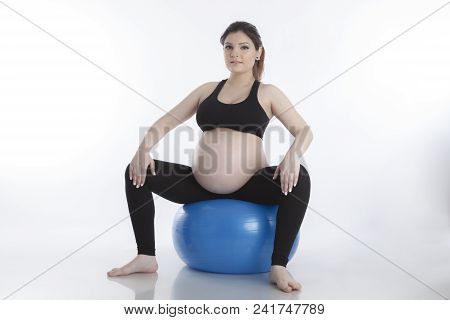 Pregnant Woman Is Doing Exercises With Gymnastic Ball On White Background