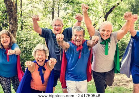 Childlike seniors wearing superhero costumes