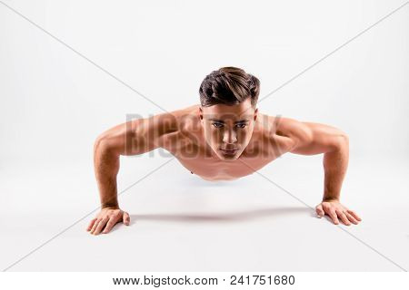 Close Up Photo Of A Sportive Muscular Handsome Diligent Determined Athlete Doing Push Ups From The F
