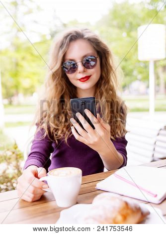 Beautifl Attractive Young Blonde Woman With Curly Hair Drinking Cappuccino And Talking On Telephone 