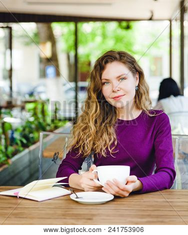 Beautiful Attractive Young Blonde Woman With Curly Hair Drinking Cappuccino And Eating Croissant In 