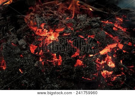 Danger, Hazard, Energy Concept. Lava Flame On Black Ash Background. Magma Textured Molten Rock Surfa