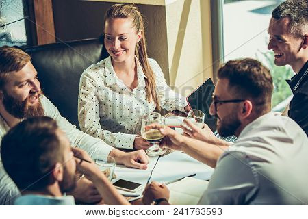 Young Cheerful People Smile And Gesture While Relaxing In Pub. Team Job. Photo Young And Mature Busi