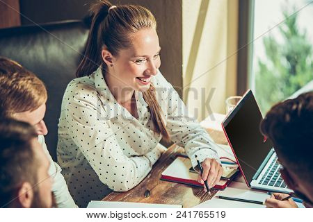 Young Cheerful People Smile And Gesture While Relaxing In Pub. Team Job. Photo Young And Mature Busi