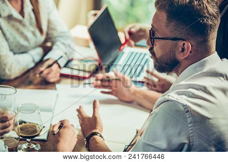 Young Cheerful People Smile And Gesture While Relaxing In Pub. Team Job. Photo Young And Mature Busi