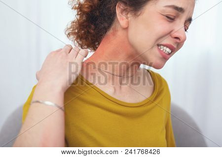 Fake Silver. Young Woman Customer Suffering From A Skin Soreness Looking Discomforted From Wearing A
