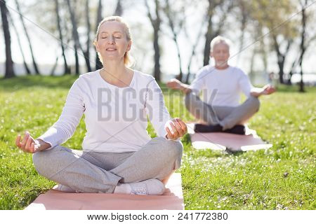 Mental Health. Pleasant Aged Woman Feeling Peaceful While Practicing Yoga