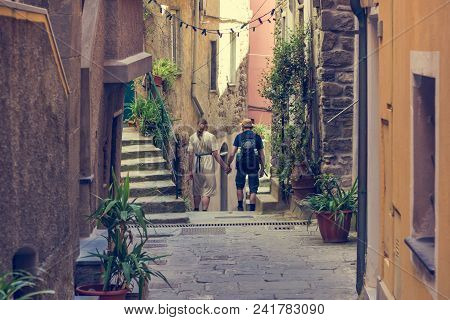 Couple Walking Through Picturesque Alley. Exploring Tourist Destinations.