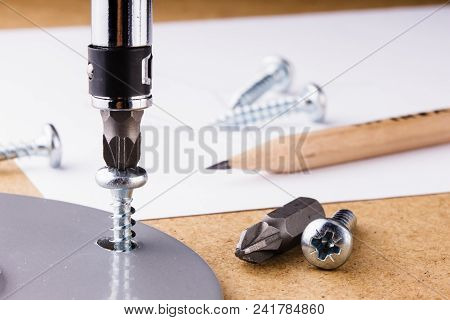 The Screwing Of The Screw With A Screwdriver.