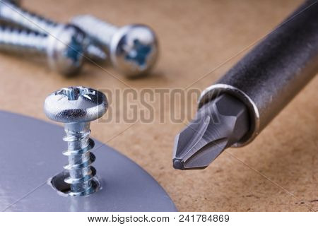The Screwing Of The Screw With A Screwdriver.