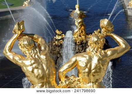 PETERHOF, ST. PETERSBURG, RUSSIA - MAY 10, 2018: Golden statues of the Grand Cascade. The cascade was built in 1715-1724 and is one of the remarkable fountain constructions in the world