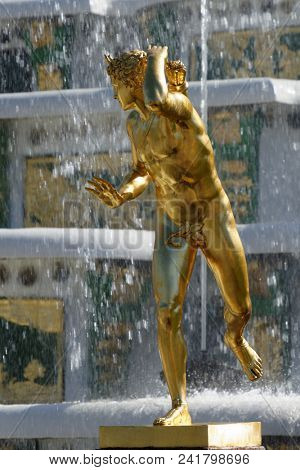 PETERHOF, ST. PETERSBURG, RUSSIA - MAY 10, 2018: Golden statues of the Grand Cascade. The cascade was built in 1715-1724 and is one of the remarkable fountain constructions in the world
