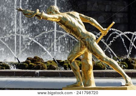 PETERHOF, ST. PETERSBURG, RUSSIA - MAY 10, 2018: Golden statues of the Grand Cascade. The cascade was built in 1715-1724 and is one of the remarkable fountain constructions in the world
