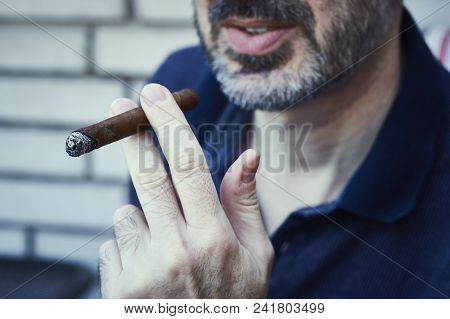 Bearded Succusful Man Chilling And Smoking Precious Cigar.
