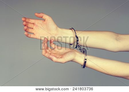 Arrested Woman Handcuffed Hands. Prisoner Or Arrested Terrorist, Close-up Of Hands In Handcuffs Isol