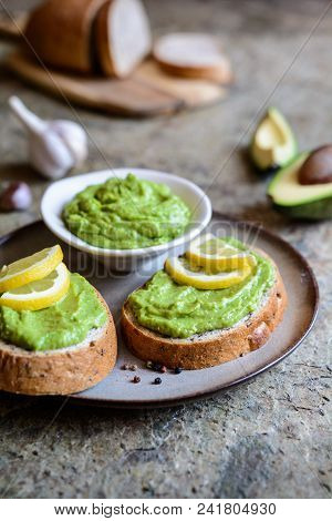 Avocado Spread With Garlic On Wholewheat Slice Of Bread