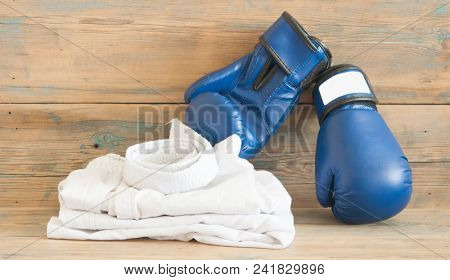 set Taekwondo equipment on a wooden background stock photos. Sports, martial arts. Protective equipment for fight in full contact