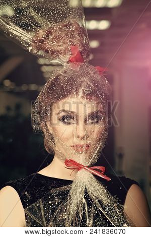 High Fashion Portrait Of Elegant Woman. Girl With Transparent Wrapper On Face, Present. Woman Face M