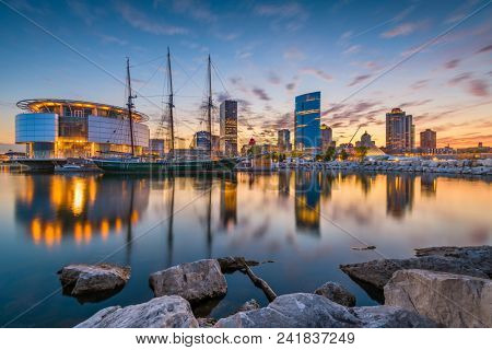 Milwaukee, Wisconsin, USA downtown city skyline on Lake Michigan at twilight.