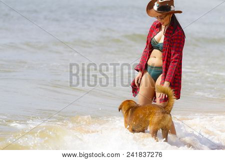Woman Happy Outdoor With Dog And Hat On Beach At Bang Beot Beach, Chumphon Province Thailand