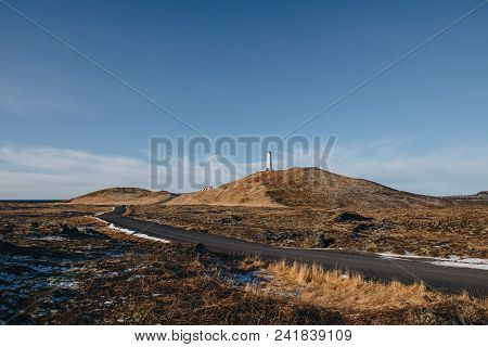 Empty Road And Lighthouse On Hill At Sunny Day In Iceland, Valahnukamol, Reykjanes