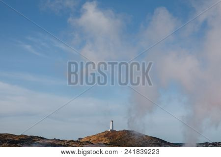 Lighthouse On Hill And Steam From Majestic Geothermal Hot Springs In Iceland, , Reykjanes, Gunnuhver