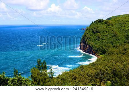 Waves Crashing Onshore To A Secluded Beach Surrounded By A Lush Green Tropical Rain Forest Taken At 