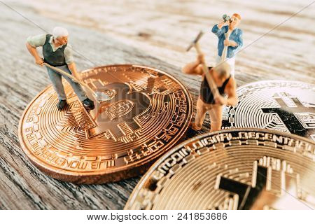 Bitcoin Mining Miniature People Diging On Valuable Coin Wood Background