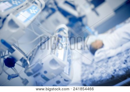 Newborn Baby Lying In The Bed Connected To The Life Support System In The Pediatric Icu, Unfocused B