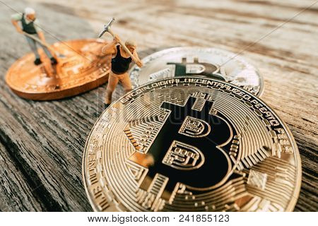 Bitcoin Mining Miniature People Diging On Valuable Coin Wood Background