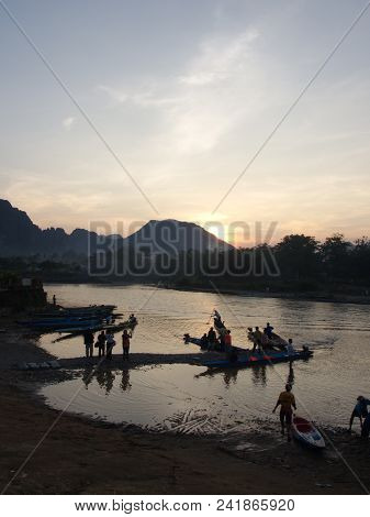 Sunset At Riverside With Mountain Background , Travel In Vang Viang City, Laos. 5Th December, 2013.