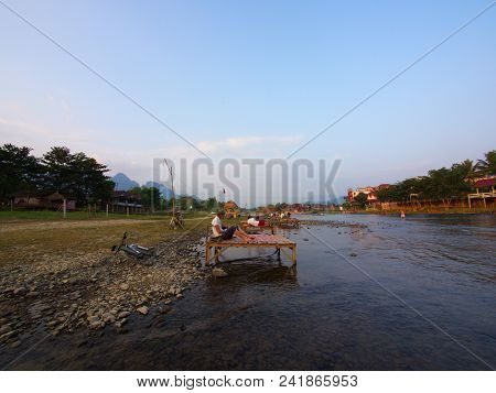 Sunset At Riverside With Mountain Background , Travel In Vang Viang City, Laos. 5Th December, 2013.
