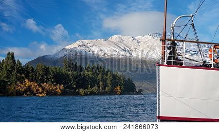 Bow Of Steamship Tss Earnslaw In Front Of Snow Covered Mountain And Blue Sky On Lake Wakatipu, New Z