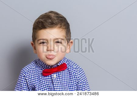 Cute Boy With Bow Tie Making A Grin