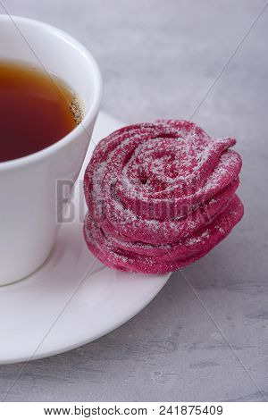 Close-up Cup Tea And Sweet Meringue Cookie On Gray Background