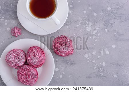 Meringues And Cup Hot Tea On Gray Background With Copy Space