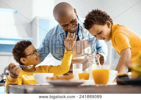 Sonly Affection. Pleasant Little Boy Caressing His Fathers Chin And Smiling Fondly While He Serving 