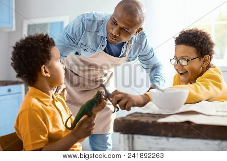 Behave Yourselves. Loving Young Father Trying To Calm Down His Little Sons While They Goofing Around