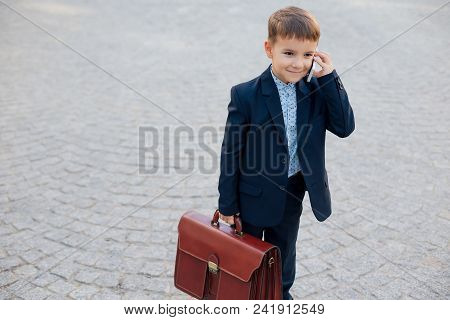 Concept Future Businessman. Portrait Of Smiling Businessman In Formal Wear Standing On Pedestrian St