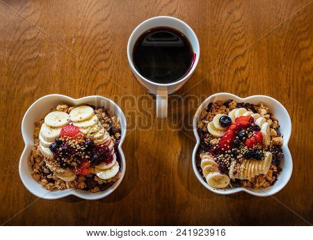 Healthy Acai Berry Bowls With Fruit And Granola And Black Coffee.